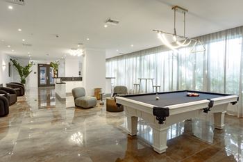 A pool table in our social club  with plush seating at Hollywood Heights on the Boulevard Luxury Apartments in Hollywood, FL
